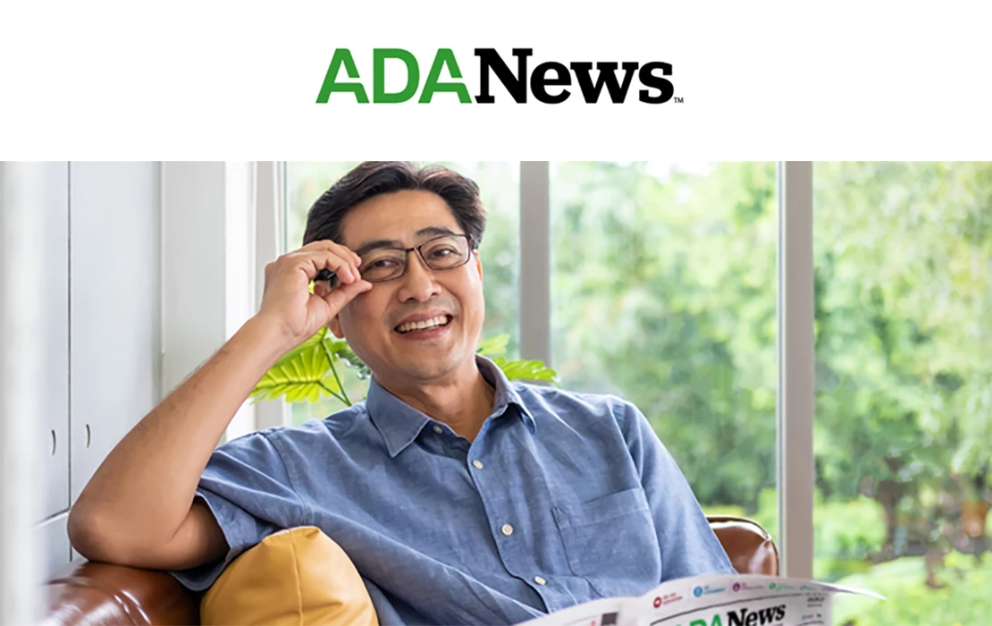 Image of a man with glasses reading the ADA News