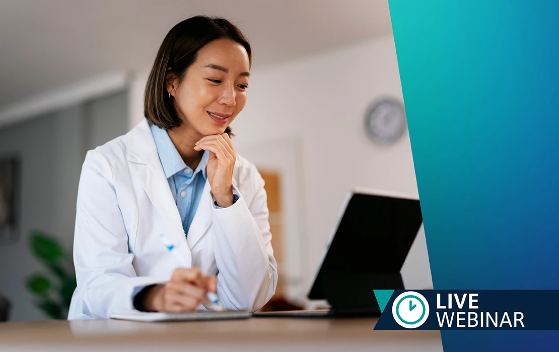 ADA Live Webinars: A female dental professional in a white coat seated looking at her computer
